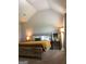 Bedroom featuring vaulted ceiling, complemented by stylish bedside lamps and window treatments at 160 Elysian Dr, Fayetteville, GA 30214