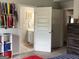 Bedroom with view to an ensuite bathroom, featuring shelving and organized decor at 160 Elysian Dr, Fayetteville, GA 30214