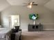 Bright bedroom with vaulted ceiling, ceiling fan, and television over gray credenza at 160 Elysian Dr, Fayetteville, GA 30214