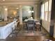 Inviting dining area features gray table with bench seating and a decorative rug, bathed in natural light at 160 Elysian Dr, Fayetteville, GA 30214