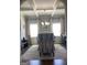 Formal dining room with coffered ceiling, modern chandelier, and elegant decor at 160 Elysian Dr, Fayetteville, GA 30214