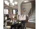 Open-concept dining area with a view to the kitchen and staircase at 160 Elysian Dr, Fayetteville, GA 30214