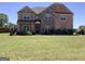 Beautiful two-story brick home with a well-manicured front yard and landscaping at 160 Elysian Dr, Fayetteville, GA 30214