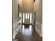 Elegant foyer featuring hardwood floors, white wainscoting, and a bright front door at 160 Elysian Dr, Fayetteville, GA 30214
