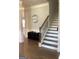 Elegant foyer featuring hardwood floors, staircase with iron railing, and decorative accents at 160 Elysian Dr, Fayetteville, GA 30214