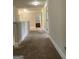 Bright hallway with neutral tones and carpet flooring leading to other rooms at 160 Elysian Dr, Fayetteville, GA 30214