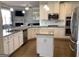 Gourmet kitchen with stainless steel appliances, granite countertops, and a kitchen island, creating a chef's dream at 160 Elysian Dr, Fayetteville, GA 30214