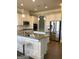 Gourmet kitchen featuring white cabinets, stainless steel appliances, and granite countertops with an island at 160 Elysian Dr, Fayetteville, GA 30214