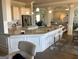 Bright kitchen boasts granite countertops, white cabinets, stainless steel appliances, and pendant lighting at 160 Elysian Dr, Fayetteville, GA 30214