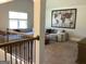 Second floor living room with hardwood floors and neutral-colored sofa at 160 Elysian Dr, Fayetteville, GA 30214