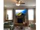 Cozy living room featuring a stone fireplace, plush seating, and ample natural light at 160 Elysian Dr, Fayetteville, GA 30214