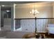 Stylish loft area with a decorative chandelier, wrought iron railing, and a cozy seating area at 160 Elysian Dr, Fayetteville, GA 30214