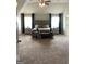 Spacious main bedroom with a ceiling fan, plush carpet, and a decorative sitting area at 160 Elysian Dr, Fayetteville, GA 30214