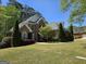 Beautiful two-story brick home with a manicured lawn, mature trees, and well-maintained landscaping at 45 Anna Dr, Covington, GA 30014
