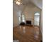 Spacious living room with hardwood floors, fireplace, high ceilings, and large arched windows at 45 Anna Dr, Covington, GA 30014