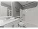 Bathroom features a white vanity, toilet, shower and tub with shelving at 421 Bear Cub Path, Social Circle, GA 30025