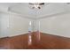 Main bedroom with hardwood floors, tray ceiling, fan, and ensuite bath at 421 Bear Cub Path, Social Circle, GA 30025