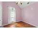 Bedroom with wood floors, a vaulted ceiling with a ceiling fan and pink walls at 421 Bear Cub Path, Social Circle, GA 30025