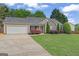 Well-maintained single-story home with a two car garage and beautiful front lawn at 421 Bear Cub Path, Social Circle, GA 30025