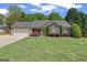 Charming single-story home with stone accents, lush lawn, and manicured landscaping at 421 Bear Cub Path, Social Circle, GA 30025