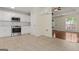 Open kitchen featuring white cabinets, stainless steel appliances, tile backsplash, and tile flooring at 421 Bear Cub Path, Social Circle, GA 30025