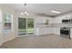 Eat-in kitchen with white cabinetry, stainless appliances, tile floor, and sliding door to the outside at 421 Bear Cub Path, Social Circle, GA 30025