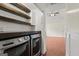 Convenient laundry room area with dark countertops, laundry units, and wood style floors at 421 Bear Cub Path, Social Circle, GA 30025
