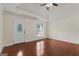 Open-concept living room with tray ceilings, wood floors, and a front entry door at 421 Bear Cub Path, Social Circle, GA 30025