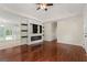 Bright and open living room features wood floors, a fireplace, and access to the kitchen at 421 Bear Cub Path, Social Circle, GA 30025