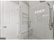 Modern shower features seamless glass, tiled walls, a bench seat, shower head and designer tile inlays at 421 Bear Cub Path, Social Circle, GA 30025