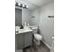 A bathroom featuring gray vanity, toilet and a large mirror at 862 Bridgewater Ct, Stone Mountain, GA 30088