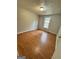 A bedroom with hardwood floors and a brightly lit window at 862 Bridgewater Ct, Stone Mountain, GA 30088