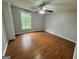 Bedroom with hardwood floors, a window overlooking a green space, and a ceiling fan at 862 Bridgewater Ct, Stone Mountain, GA 30088