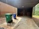 Open carport with a concrete floor and a wooden back wall at 862 Bridgewater Ct, Stone Mountain, GA 30088