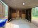Open carport with a concrete floor and a wooden back wall at 862 Bridgewater Ct, Stone Mountain, GA 30088