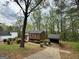 Wide shot of house and carport showing landscaping and cloudy sky at 862 Bridgewater Ct, Stone Mountain, GA 30088