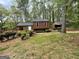 Front view of the house and carport in a grassy setting with landscaping at 862 Bridgewater Ct, Stone Mountain, GA 30088