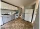 A kitchen featuring gray cabinets, white appliances, and neutral countertops at 862 Bridgewater Ct, Stone Mountain, GA 30088