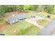 Aerial view of a well-maintained home featuring a long driveway, lush landscaping, and multiple parking spaces at 140 Stoneview Cir, Covington, GA 30016