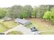 Lush green property with a charming home, long driveway with plentiful parking, and serene wooded surroundings at 140 Stoneview Cir, Covington, GA 30016