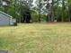 Expansive backyard with a lush lawn and mature trees, offering a serene and private outdoor space at 140 Stoneview Cir, Covington, GA 30016