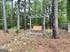 Secluded backyard featuring a charming wooden swing set, nestled among mature trees for a peaceful retreat at 140 Stoneview Cir, Covington, GA 30016