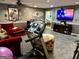 Finished basement offering a home gym, living space, and entertainment area with a large-screen TV at 140 Stoneview Cir, Covington, GA 30016