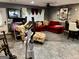 Open basement featuring a comfortable seating area, gym equipment, and a modern entertainment system at 140 Stoneview Cir, Covington, GA 30016