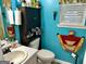 Bright bathroom featuring blue walls, white sink and cabinet at 140 Stoneview Cir, Covington, GA 30016
