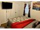 Bedroom featuring a bed, wall-mounted TV, white door and colorful curtains at 140 Stoneview Cir, Covington, GA 30016