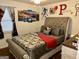 Comfortable bedroom featuring a plush bed with decorative pillows and unique wall art at 140 Stoneview Cir, Covington, GA 30016