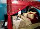 Elegant bedroom with a four-poster bed, decorative pillows, and red canopy at 140 Stoneview Cir, Covington, GA 30016