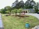 Well-manicured front yard with lush green grass, retaining wall, and a covered porch at 140 Stoneview Cir, Covington, GA 30016