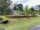 Well-manicured front yard, retaining wall, and a home with a covered front porch at 140 Stoneview Cir, Covington, GA 30016